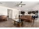 Open-concept living area with tile floors, connecting the living room to the kitchen, ideal for entertaining at 9342 W White Feather Ln, Peoria, AZ 85383