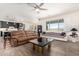 Open-concept living room boasts wood-look tile flooring, neutral paint, and seamless flow to the kitchen at 9342 W White Feather Ln, Peoria, AZ 85383