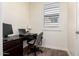 Cozy office space with a modern desk, comfortable chair, and a window providing natural light at 9342 W White Feather Ln, Peoria, AZ 85383
