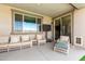 Cozy covered patio with comfortable seating, offering a pleasant outdoor living space for relaxation at 9342 W White Feather Ln, Peoria, AZ 85383