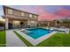 Beautiful backyard featuring a sparkling pool and lush green grass, ideal for outdoor entertainment at 9342 W White Feather Ln, Peoria, AZ 85383