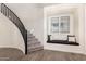 Elegant staircase with a black railing and a cozy window seat for relaxation and added charm at 9342 W White Feather Ln, Peoria, AZ 85383
