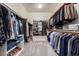 Spacious walk-in closet with ample shelving, hanging rods, and shoe storage for organization at 9342 W White Feather Ln, Peoria, AZ 85383