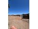 A large, empty lot backyard with fencing, desert landscape, and a clear blue sky at 9754 E Sunland Ave, Mesa, AZ 85208