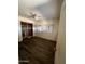 Bedroom with damaged floor, a ceiling fan, a closet with shelving, and blank white walls at 9754 E Sunland Ave, Mesa, AZ 85208