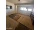 Empty bedroom with damaged flooring and shelving unit at 9754 E Sunland Ave, Mesa, AZ 85208