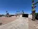Exterior of a single-story mobile home with a carport and desert landscaping and tall saguaro cactus at 9754 E Sunland Ave, Mesa, AZ 85208