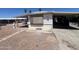 Exterior side view of single-story home with a carport on a gravel lot with desert landscaping at 9754 E Sunland Ave, Mesa, AZ 85208
