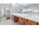 Bright bathroom with double vanity, spacious counters, and a large mirror with updated lighting at 10351 W Carlota Ln, Peoria, AZ 85383