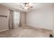 Neutral bedroom with carpet, ceiling fan, window, and ample natural light at 10351 W Carlota Ln, Peoria, AZ 85383