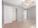 Carpeted bedroom with ceiling fan, closet, and neutral color scheme at 10351 W Carlota Ln, Peoria, AZ 85383
