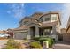 Charming two-story home with a well-manicured desert rock landscape in front at 10351 W Carlota Ln, Peoria, AZ 85383