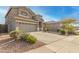 Charming two-story home with a well-manicured desert rock landscape in front at 10351 W Carlota Ln, Peoria, AZ 85383