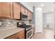 A modern kitchen featuring stainless steel appliances, gas range, and stylish backsplash at 10351 W Carlota Ln, Peoria, AZ 85383