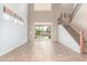 Spacious living room with high ceilings, staircase, and sliding glass doors to the backyard pool at 10351 W Carlota Ln, Peoria, AZ 85383