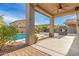 Covered patio with decorative columns, ceiling fan, pool, and playhouse at 10351 W Carlota Ln, Peoria, AZ 85383