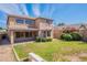 Exterior view of the home's backyard, with green grass, a block wall, and a covered patio at 10517 W La Reata Ave, Avondale, AZ 85392