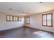 Spacious bedroom featuring wood-look flooring and several bright windows at 10517 W La Reata Ave, Avondale, AZ 85392