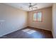 Bedroom featuring natural light, wood-look flooring and a ceiling fan at 10517 W La Reata Ave, Avondale, AZ 85392