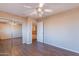 Bedroom with wood-look flooring with closet and second floor views at 10517 W La Reata Ave, Avondale, AZ 85392