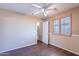 Neutral toned bedroom with wood-look flooring, a ceiling fan and bright windows at 10517 W La Reata Ave, Avondale, AZ 85392
