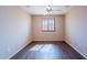 Airy bedroom with wood-look flooring and bright windows at 10517 W La Reata Ave, Avondale, AZ 85392