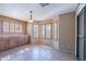 Cozy breakfast nook with tiled floors, bright windows with plantation shutters and a stylish light fixture at 10517 W La Reata Ave, Avondale, AZ 85392