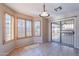 Bright breakfast nook featuring tiled flooring, patio access, and plantation shutters at 10517 W La Reata Ave, Avondale, AZ 85392