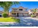 Inviting two-story home featuring a three-car garage, charming balcony, and a well-manicured front yard at 10517 W La Reata Ave, Avondale, AZ 85392