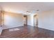 Spacious living room showcasing wood-look floors, ceiling fan, and access to additional rooms at 10517 W La Reata Ave, Avondale, AZ 85392