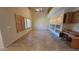 Spacious living room with tile flooring, built-in shelving, and large windows at 10517 W La Reata Ave, Avondale, AZ 85392