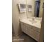 Bathroom with a single sink vanity, white cabinets, a large mirror and towel racks at 10610 S 48Th St # 1074, Phoenix, AZ 85044