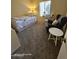 Cozy bedroom with a twin bed, a desk by the window and a comfortable chair, perfect for relaxing and studying at 10610 S 48Th St # 1074, Phoenix, AZ 85044