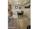 Cozy dining area featuring tile floors, a modern light fixture, and a dark table with chairs at 10610 S 48Th St # 1074, Phoenix, AZ 85044