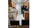 Functional kitchen featuring wooden cabinets, granite countertops, and modern appliances at 10610 S 48Th St # 1074, Phoenix, AZ 85044