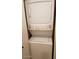 Efficient laundry closet with a stacked washer and dryer, maximizing space in the unit at 10610 S 48Th St # 1074, Phoenix, AZ 85044
