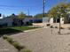 The backyard features low-maintenance desert landscaping and a brick patio at 112 W Vogel Ave, Phoenix, AZ 85021