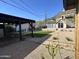 Charming backyard featuring artificial turf, desert landscaping, and a cozy shed with french doors at 112 W Vogel Ave, Phoenix, AZ 85021