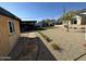 Backyard with desert landscaping and stone walkway leading to a covered patio at 112 W Vogel Ave, Phoenix, AZ 85021