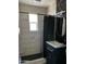 Modern bathroom with updated vanity, tiled shower, and unique wallpaper at 112 W Vogel Ave, Phoenix, AZ 85021