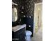 Stylish half bathroom featuring dark floral wallpaper and modern fixtures at 112 W Vogel Ave, Phoenix, AZ 85021