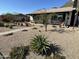 Well-maintained front yard with desert landscaping and mature trees at 112 W Vogel Ave, Phoenix, AZ 85021