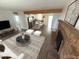 Open concept living room showcasing a modern kitchen, brick fireplace, and hardwood style floors at 112 W Vogel Ave, Phoenix, AZ 85021