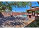 Spacious backyard with a pool, covered patio, and a fully fenced perimeter for privacy at 1220 E Avenida Ellena St, Casa Grande, AZ 85122
