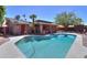 A refreshing backyard swimming pool with a covered porch and lush green trees around the perimeter at 1220 E Avenida Ellena St, Casa Grande, AZ 85122