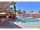 Relaxing backyard swimming pool with a covered patio area and lush landscaping at 1220 E Avenida Ellena St, Casa Grande, AZ 85122