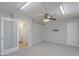 Spacious carpeted bedroom with a ceiling fan and an adjacent bathroom and walk-in closet at 1220 E Avenida Ellena St, Casa Grande, AZ 85122