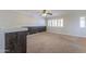 Spacious bonus room with modern wood detail, carpet flooring, and a ceiling fan at 1220 E Avenida Ellena St, Casa Grande, AZ 85122