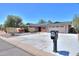 Charming one-story home with desert landscaping, a two-car garage, and a large driveway at 1220 E Avenida Ellena St, Casa Grande, AZ 85122