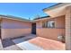 Charming exterior detail featuring brick accents, a window, and a black front door at 1220 E Avenida Ellena St, Casa Grande, AZ 85122
